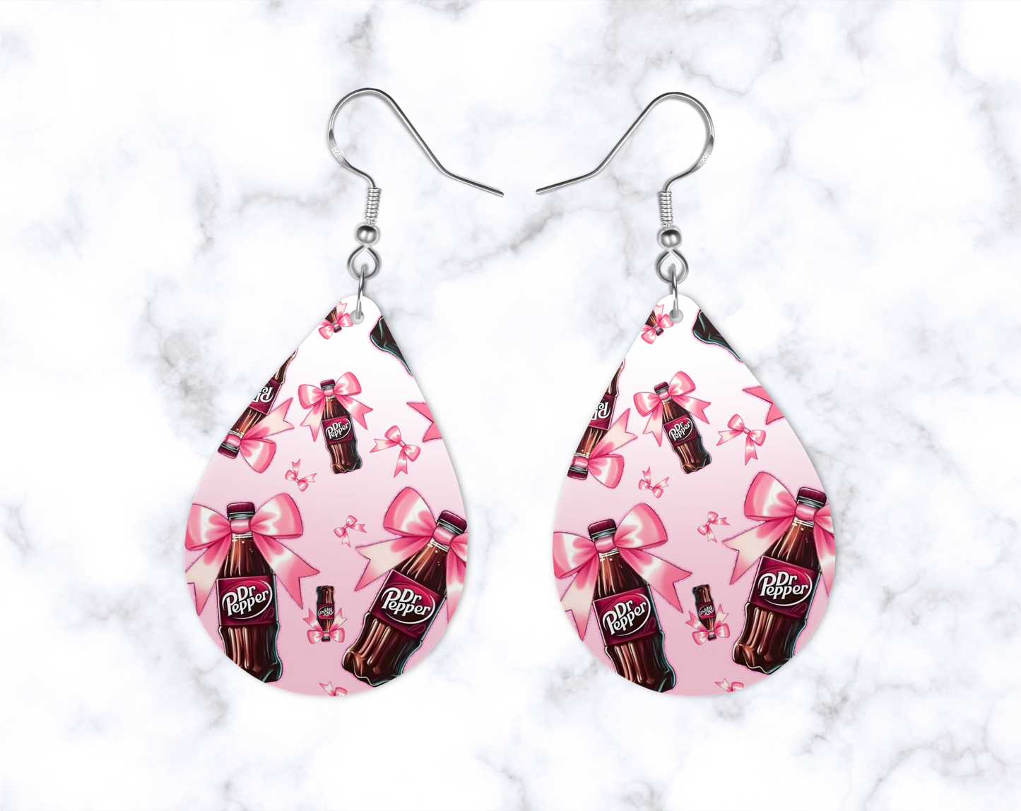 Handcrafted custom teardrop earrings with playful pink bow and bottle design.