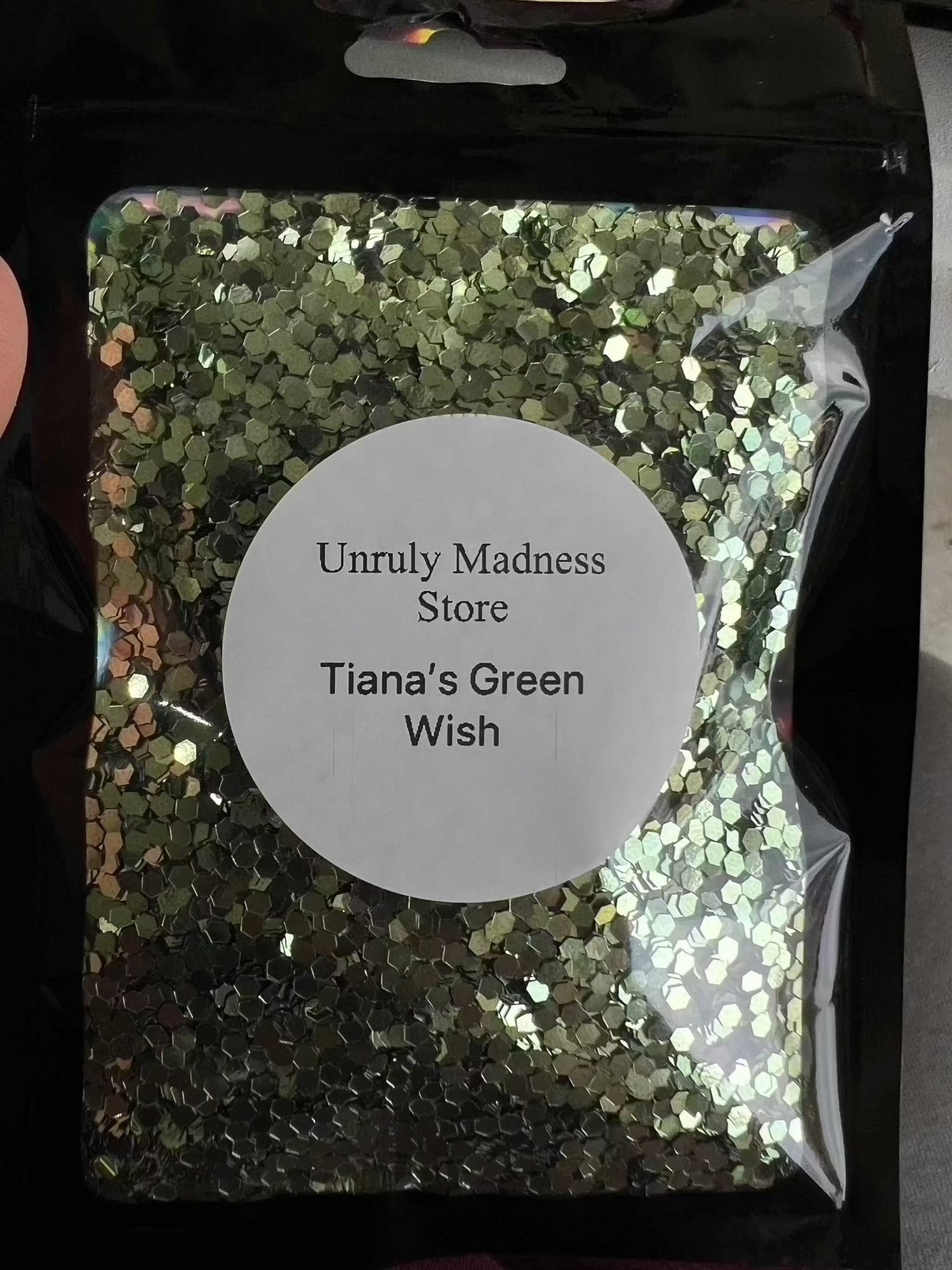 2oz Glitter in green shade, packaged in a secure bag with label 'Tiana's Green Wish', ideal for crafting and adding sparkle to projects.