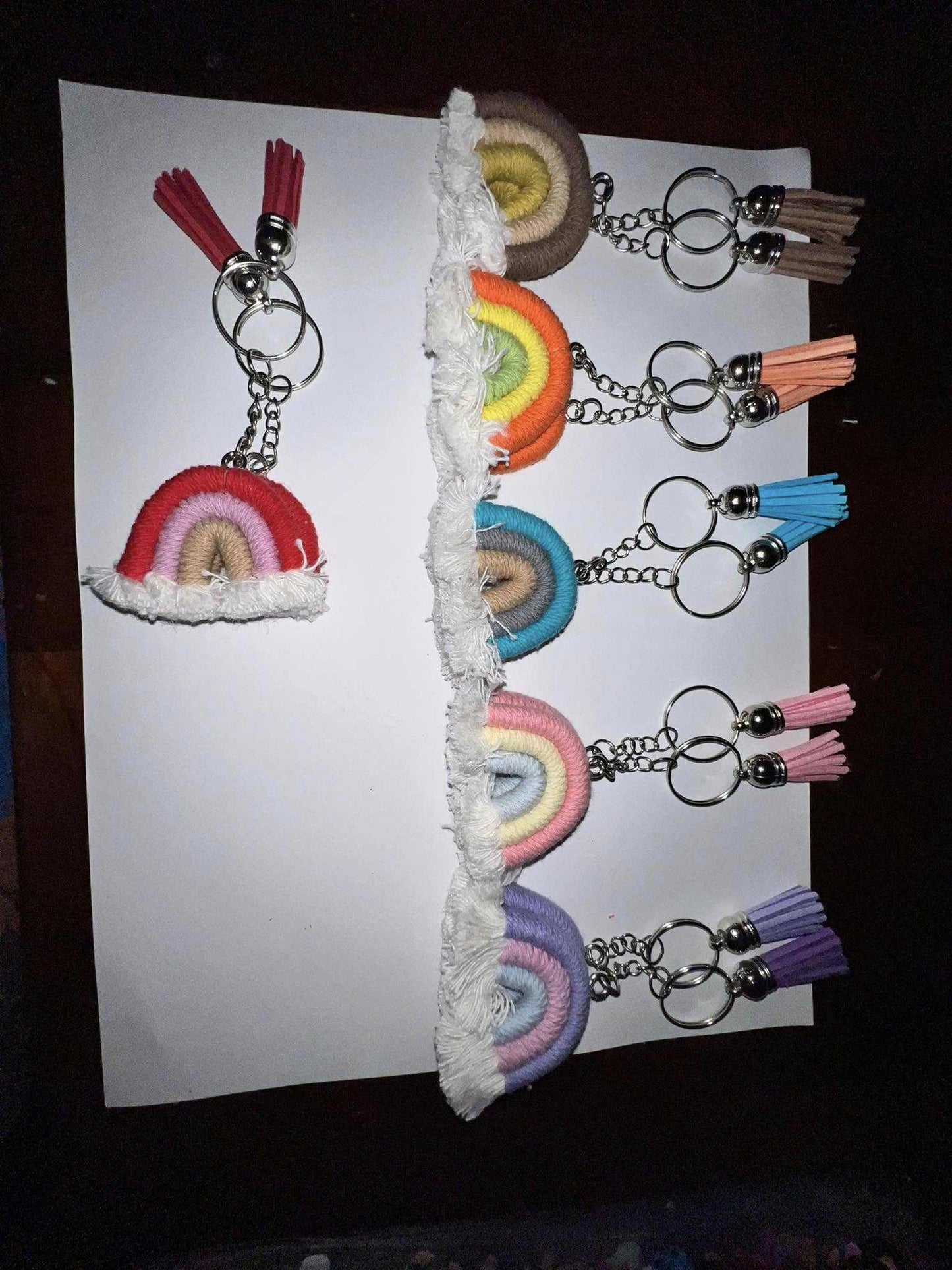 Boho keychains with rainbow designs, tassels, and vibrant patterns.