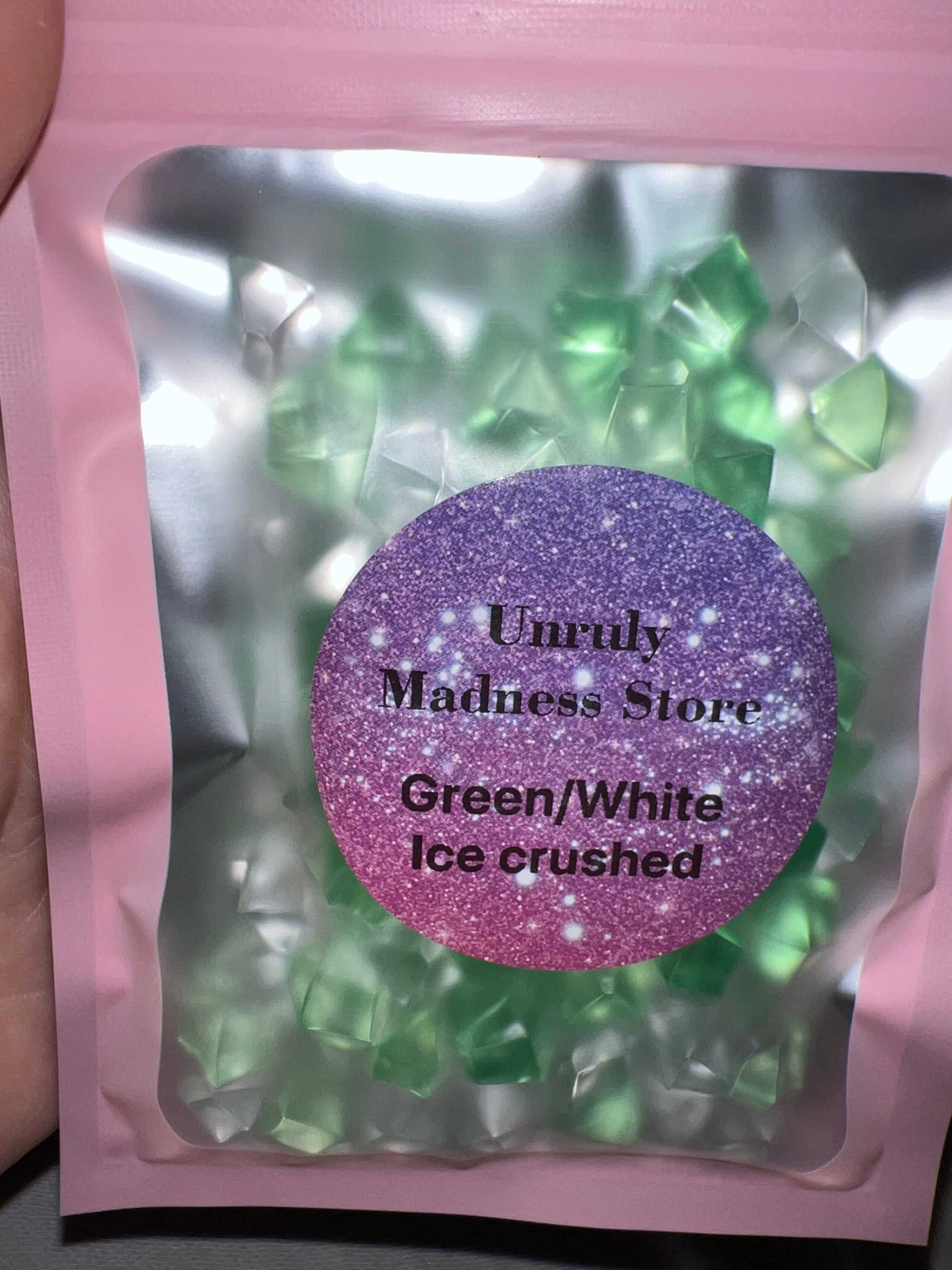 Green and white crushed ice glitter in pink resealable bag