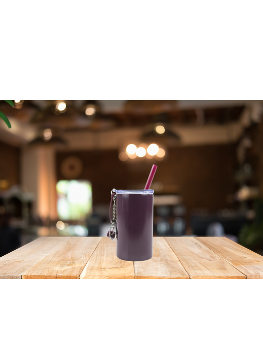 steel Tumbler with straw on wooden table in cozy cafe setting