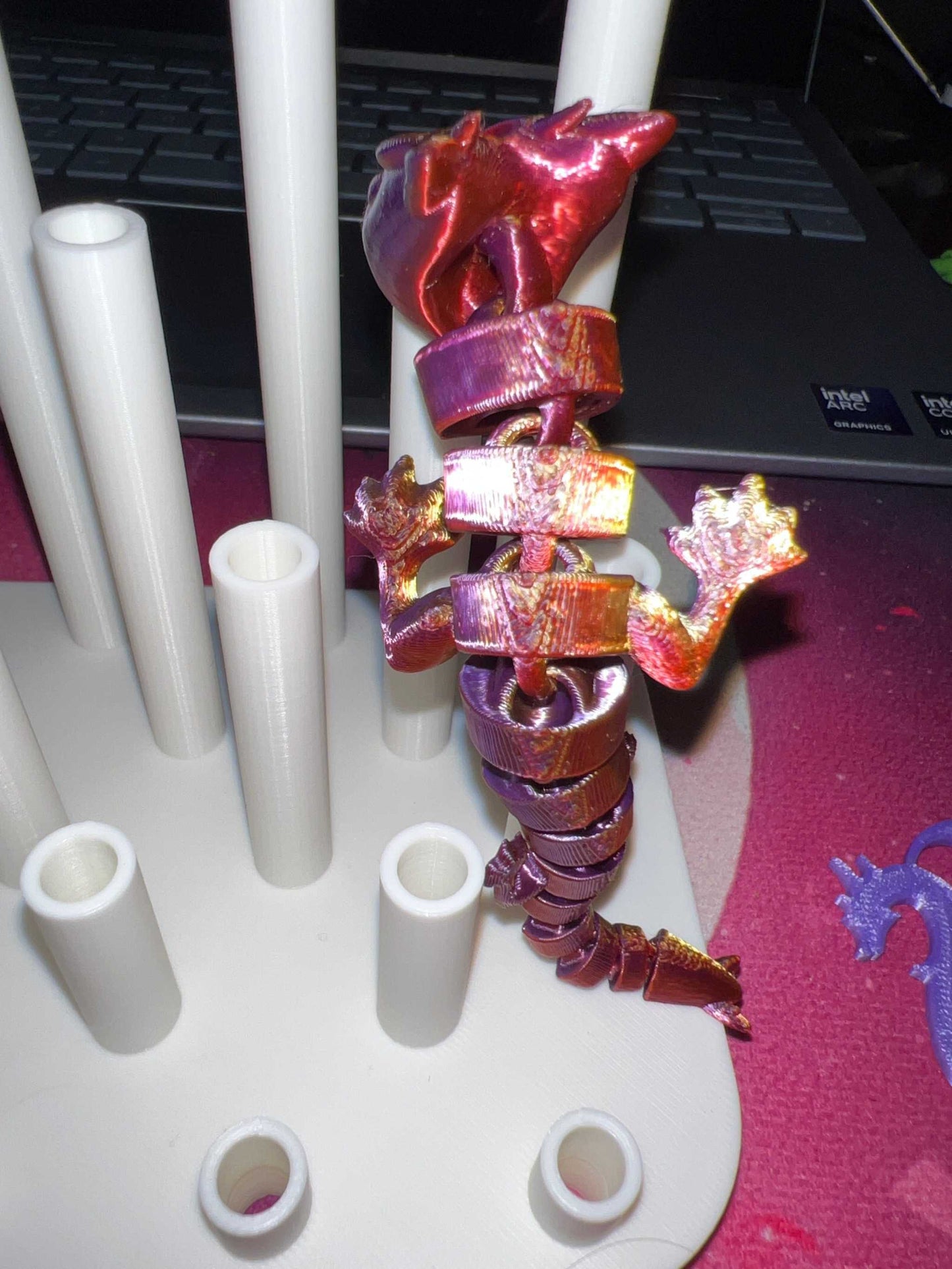 3D printed metallic red dragon straw topper wrapped around a white straw drying rack