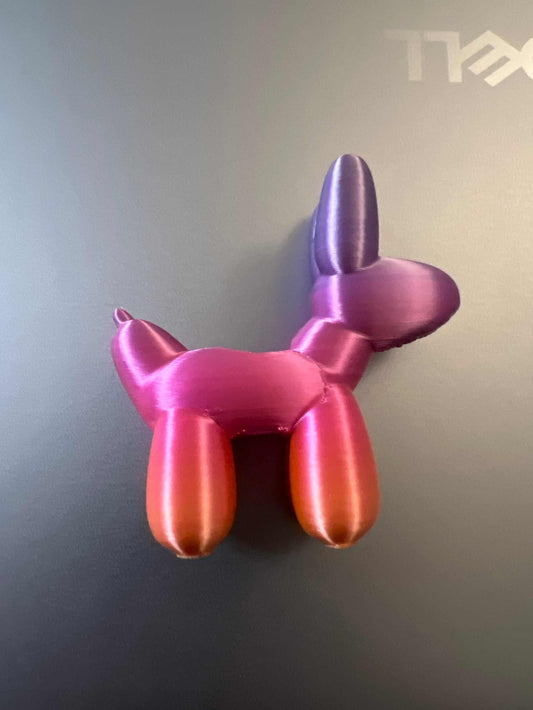Pink and purple balloon dog straw topper accessory on gray background