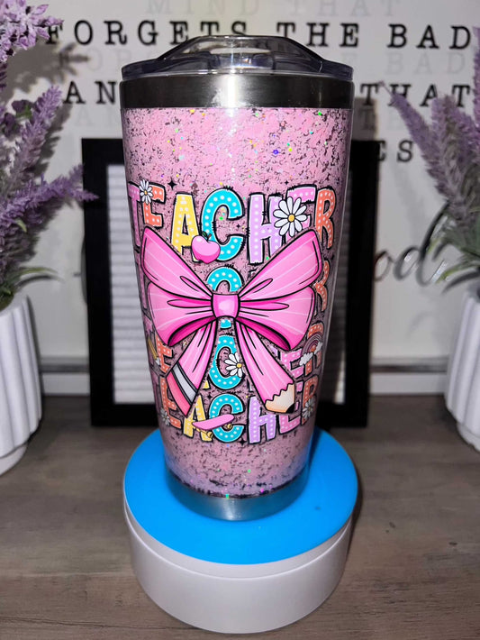 Pink tumbler storyboard with colorful printed design featuring bow and floral elements.
