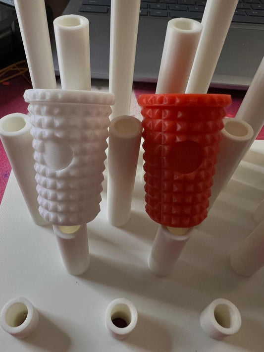 Dupe Tumbler straw toppers in white and red with textured grip on white straws