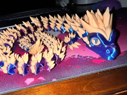 XL dragon figurine with purple and orange spiked body and detailed head on a surface