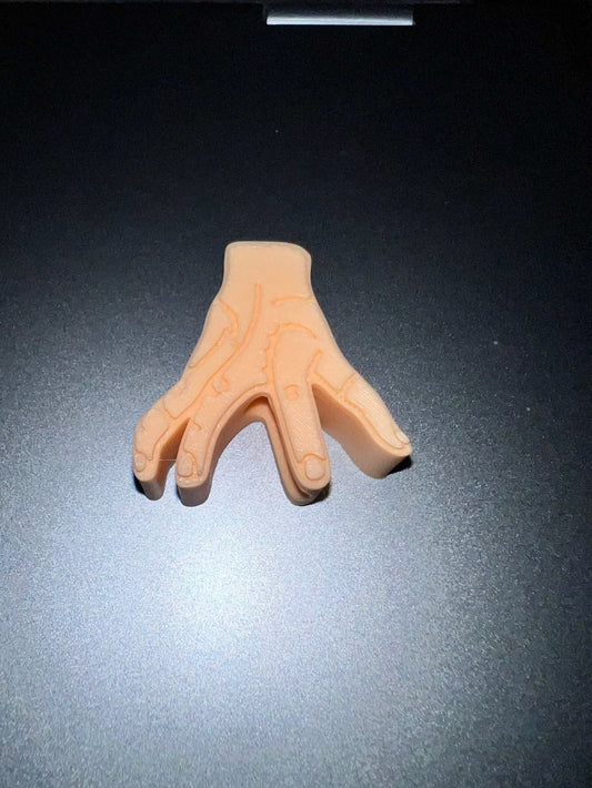 Rubber right hand model with detailed finger lines on dark surface