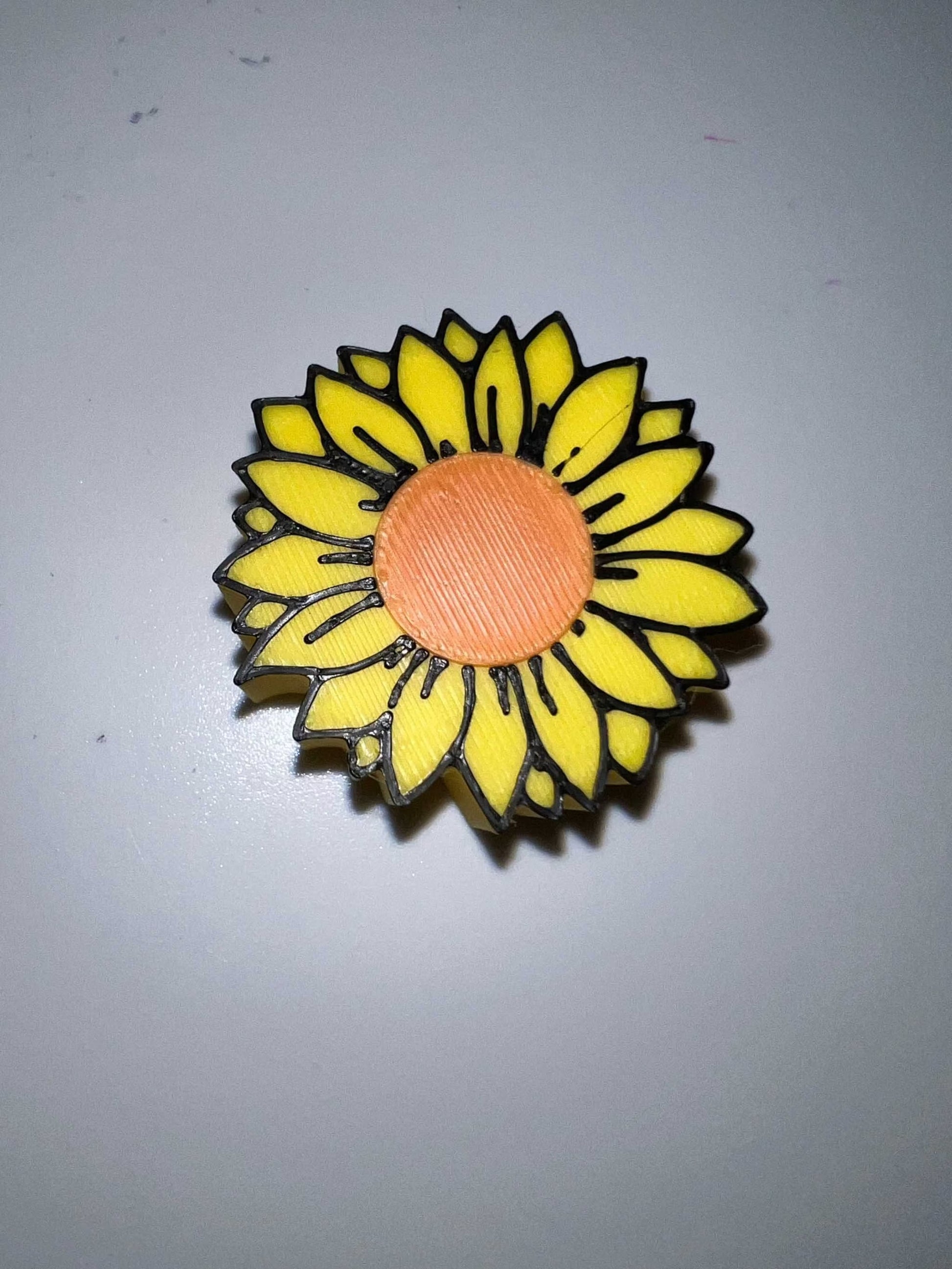 Sun Flower strawtopper with yellow petals and orange center on a white background
