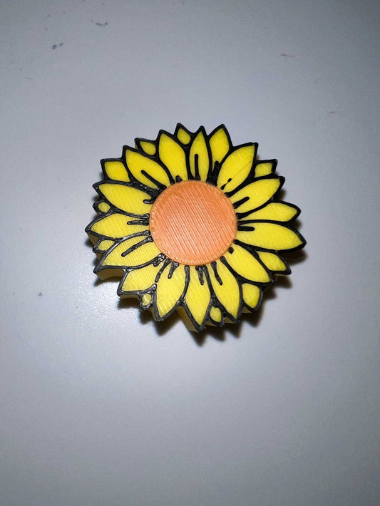 Sun Flower strawtopper with yellow petals and orange center on a white background