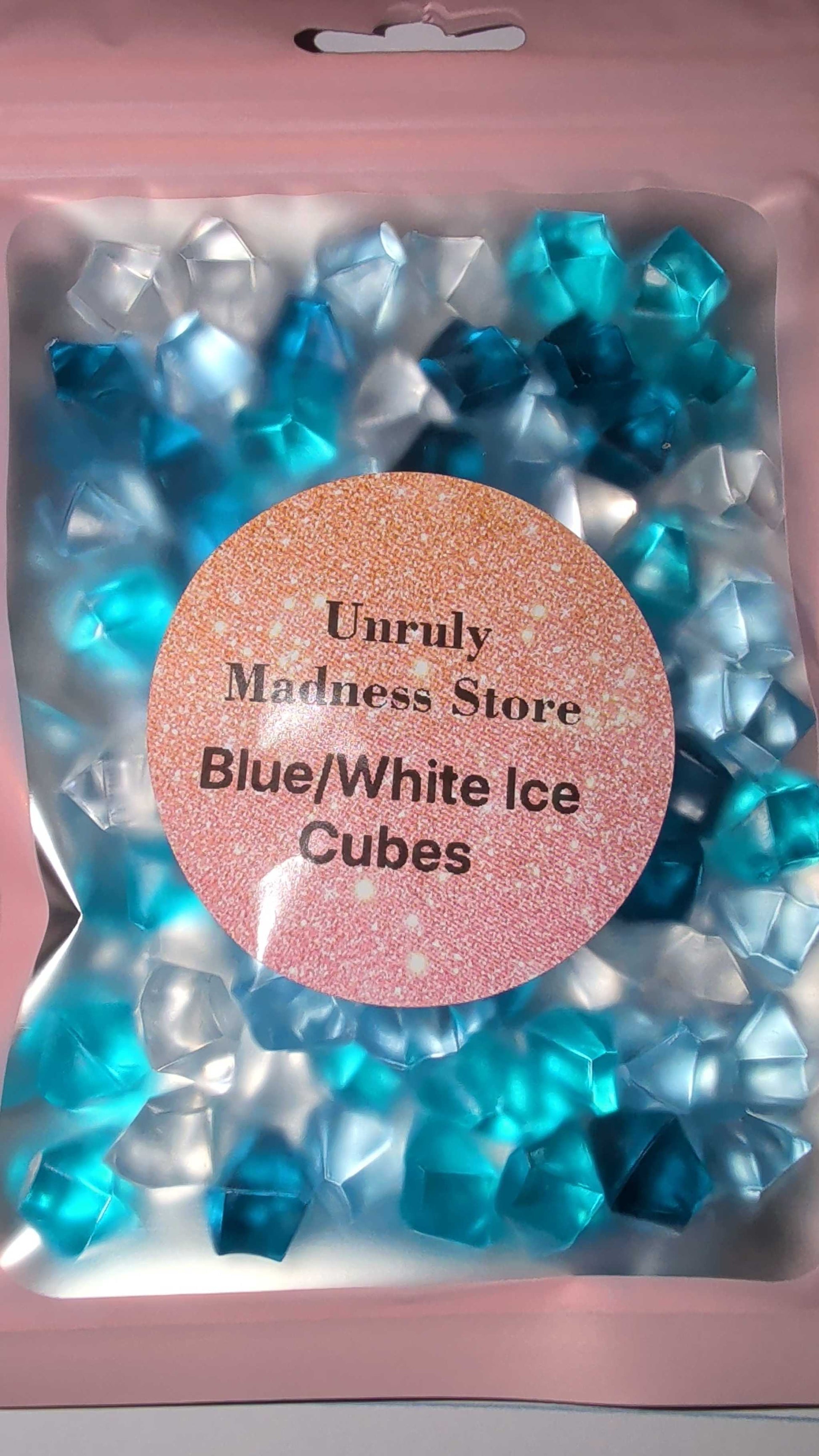 Blue and white 2 colored ice cubes in a pink resealable bag with glitter label