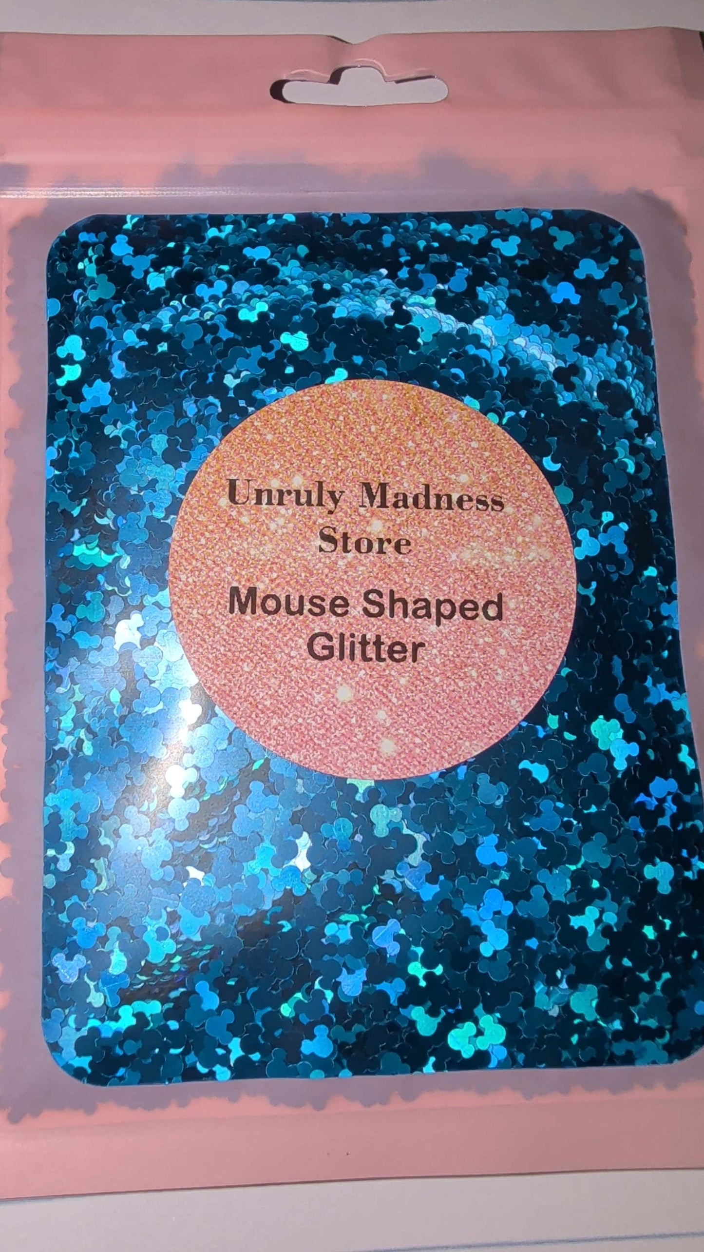 Blue mouse shaped polyester glitter in resealable pink pouch from Unruly Madness Store