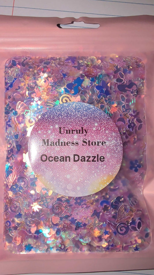 Ocean Dazzle 2oz polyester glitter in iridescent ocean-themed shapes and colors in resealable pink pouch