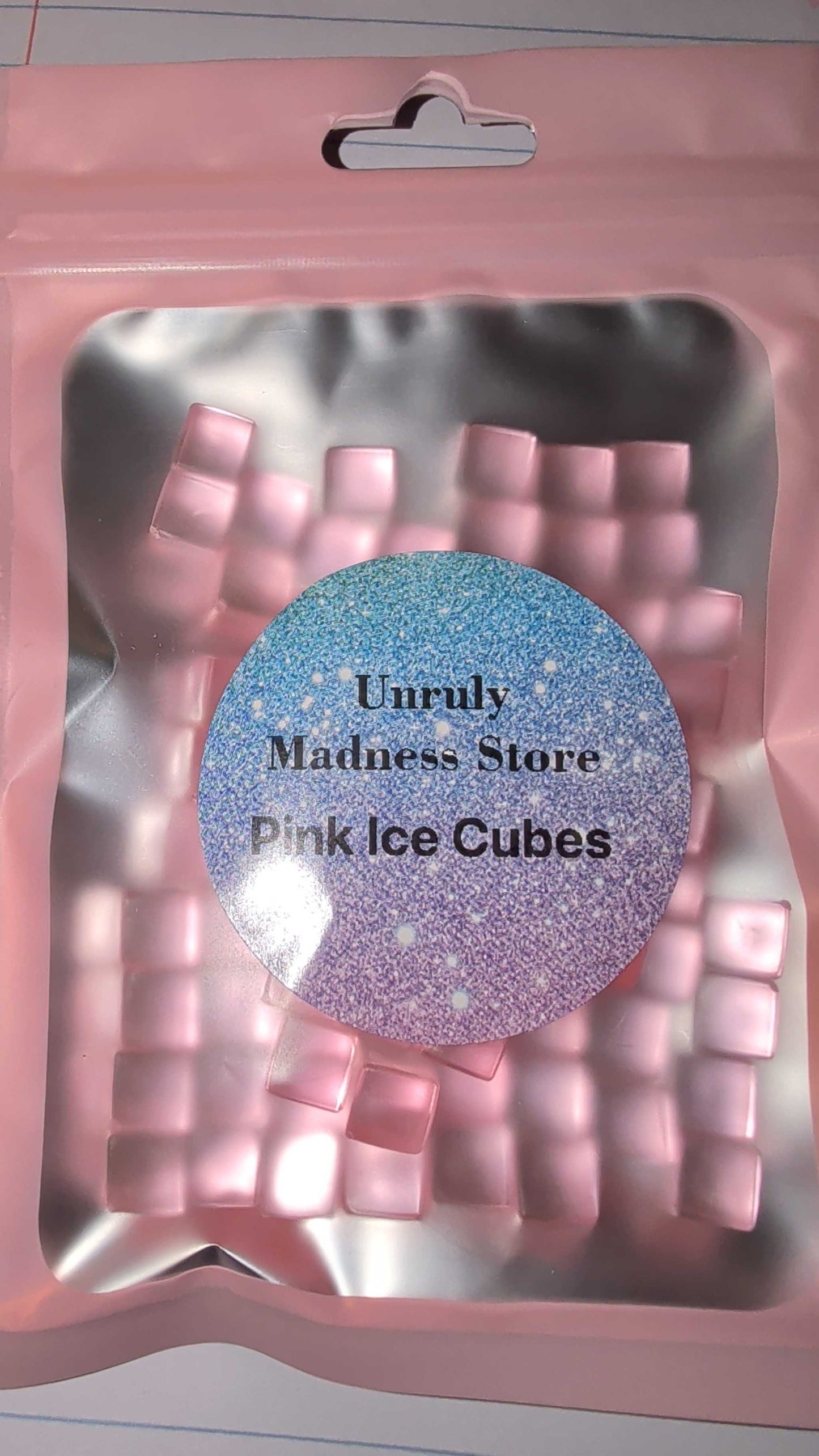 Package of pink ice cubes made of 2oz polyester glitter from Unruly Madness Store